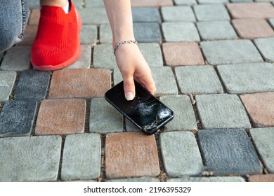 Young Woman Holding Broken Phone