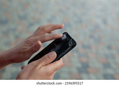 Young Woman Holding Broken Phone