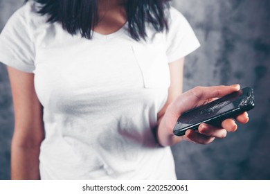 Young Woman Holding Broken Phone