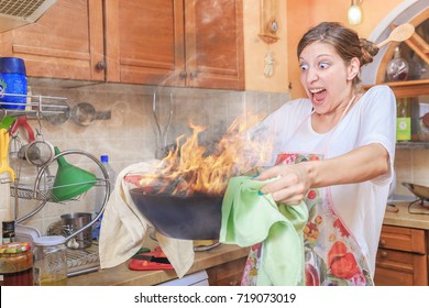 Young woman holding a burning bowl, screaming terrified, flames rising high