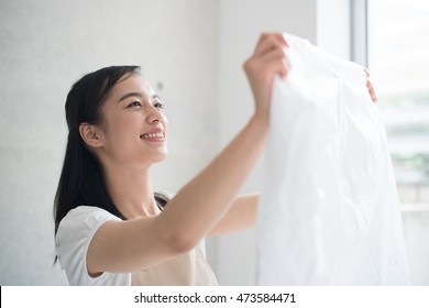 Young Woman Holding Clean Laundry