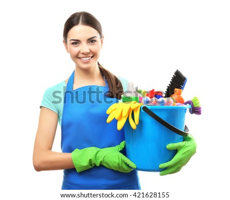 Young woman holding cleaning tools and products in bucket, isolated on white