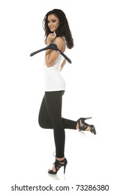 Young Woman Holding Clothes Hanger On Finger Looking At Camera Isolated On White Background