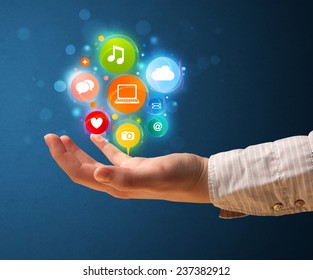 Young woman holding colorful multimedia icons in her hand - Shutterstock ID 237382912