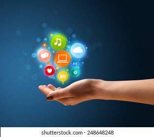 Young woman holding colorful multimedia icons in her hand - Shutterstock ID 248648248