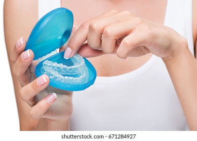 Young Woman Holding Cover With Clear Aligners