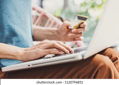 Young Woman Holding Credit Card And Using Laptop Computer, Travel And Online Shopping Concept