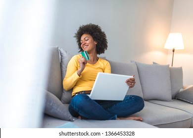 Young woman holding credit card and using laptop computer. Online shopping concept. Woman with computer shopping online. Credit Card Online Technology Shopping - Shutterstock ID 1366453328