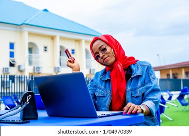 Young Woman Holding Credit Card Using Laptop At Home Shopping Due To Isolation Of Staying At Home  In Quarantine