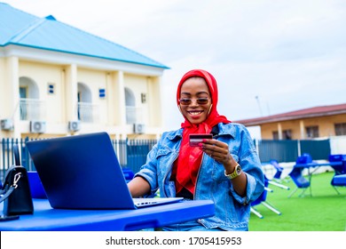 Young Woman Holding Credit Card Using Laptop At Home Shopping Due To Isolation Of Staying At Home  In Quarantine