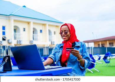 Young Woman Holding Credit Card Using Laptop At Home Shopping Due To Isolation Of Staying At Home  In Quarantine