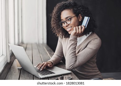 Young woman holding credit card and using laptop making payment online. Businesswoman or entrepreneur working at home. Online shopping, e-commerce, banking, internet store, spending money concept - Powered by Shutterstock