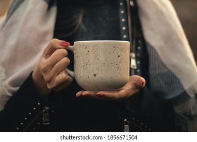 Young Woman Holding A Cup Of Hot Tea Outside. Steam From A Cup Of Hot Tea.