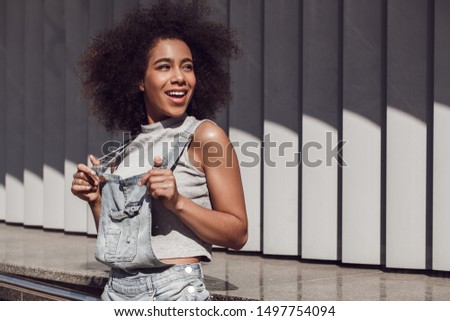 Similar – Image, Stock Photo Happy mixed woman with curly hair standing on the street