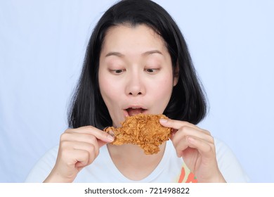 Young Woman Holding And Eating Fries Chicken