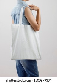 Young Woman Holding Eco Cotton Bag On White Background