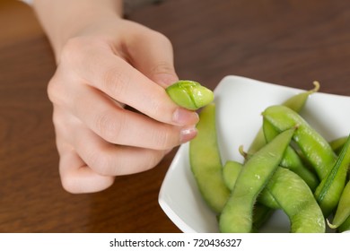 Young Woman Holding Edamame