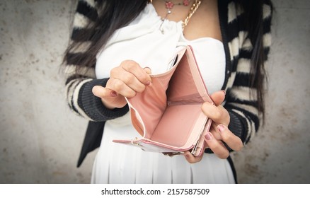 Young Woman Holding Empty Wallet. No Money