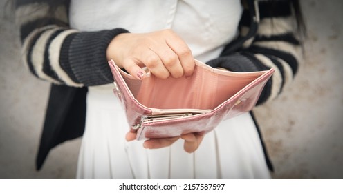 Young Woman Holding Empty Wallet. No Money