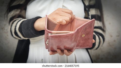 Young Woman Holding Empty Wallet. No Money