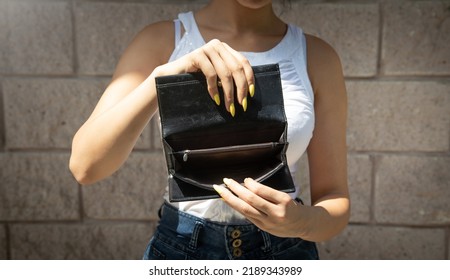 Young Woman Holding Empty Wallet. No Money