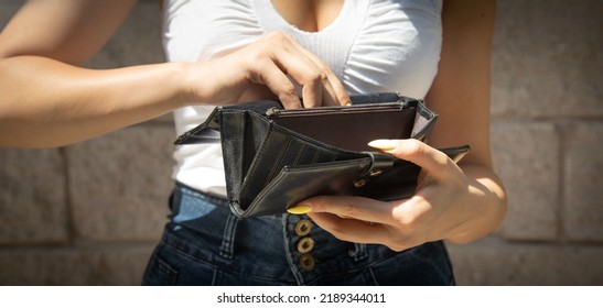 Young Woman Holding Empty Wallet. No Money