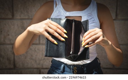 Young Woman Holding Empty Wallet. No Money