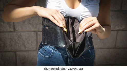 Young Woman Holding Empty Wallet. No Money