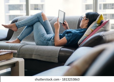 Young Woman Holding Ereader And Reading Ebook