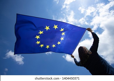 Young woman holding European Union flag. Voting, election concept. - Shutterstock ID 1404450371
