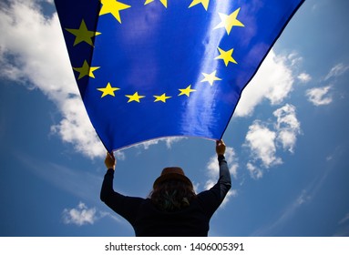 Young woman holding European Union flag. Voting, election concept. - Shutterstock ID 1406005391