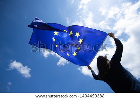 Young woman holding European Union flag. Voting, election concept.