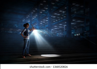 Young Woman Holding A Flashlight