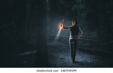 Young Woman Holding A Flashlight