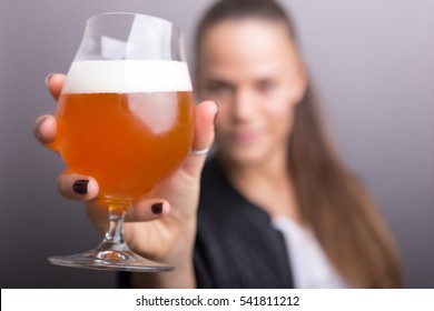 Young Woman Holding Fresh Beer. Isolated Gray.