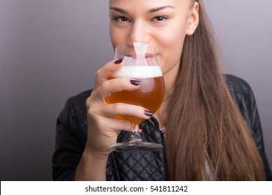 Young Woman Holding Fresh Beer. Isolated Gray.