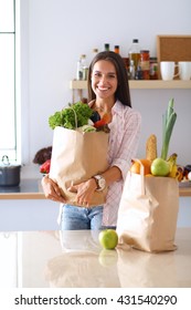 Young Woman Holding Grocery Shopping Bag With Vegetables