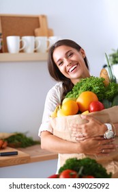 Young Woman Holding Grocery Shopping Bag With Vegetables