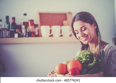 Young Woman Holding Grocery Shopping Bag With Vegetables