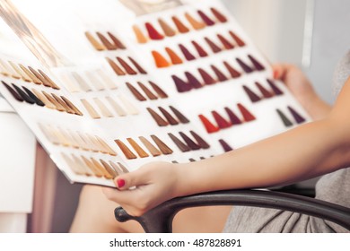 Young Woman Holding Hair Color Swatches. 