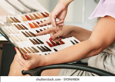 Young Woman Holding Hair Color Swatches. 