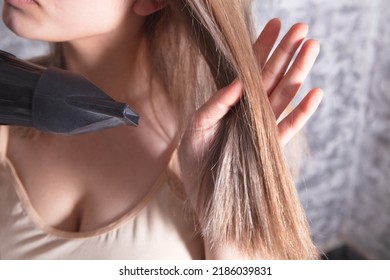 Young Woman Holding Hair Dryer