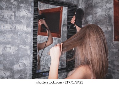 Young Woman Holding Hair Dryer