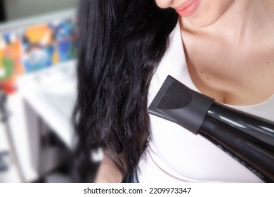 Young Woman Holding Hair Dryer