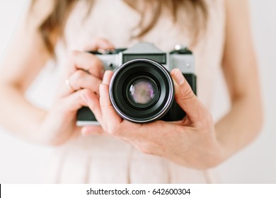 Young Woman Holding In Hands Old Vintage Camera. Girl Photographer And Film Camera