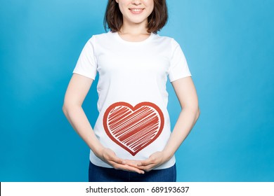 young woman holding a heart symbol. - Shutterstock ID 689193637