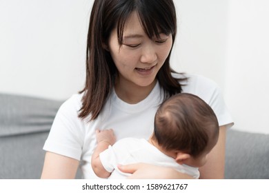 Young woman holding her baby