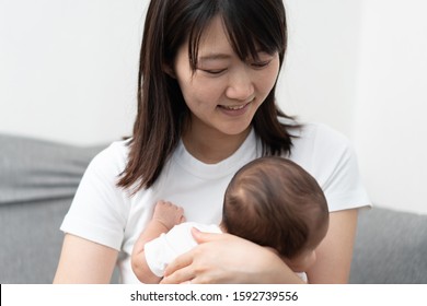 Young woman holding her baby