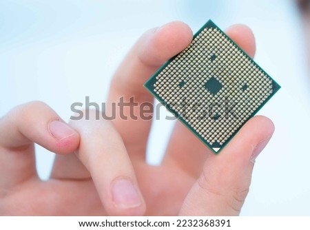 young woman holding in her hands the central processing unit for a laptop