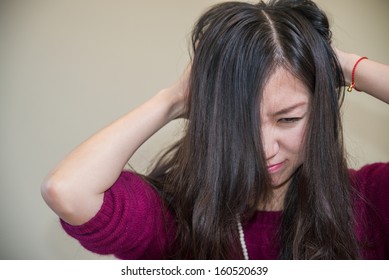 Young woman holding her head looking frustrated
